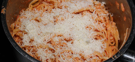 Nüdeli mit geriebenem Parmesan vermischen